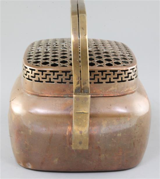 A large Chinese copper alloy hand warmer, 17th / 18th century, width 27cm